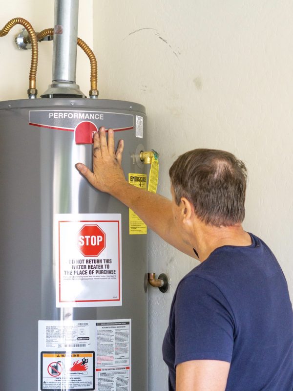 adult-male-with-hand-on-newly-installed-hot-water-2021-08-29-08-48-09-utc